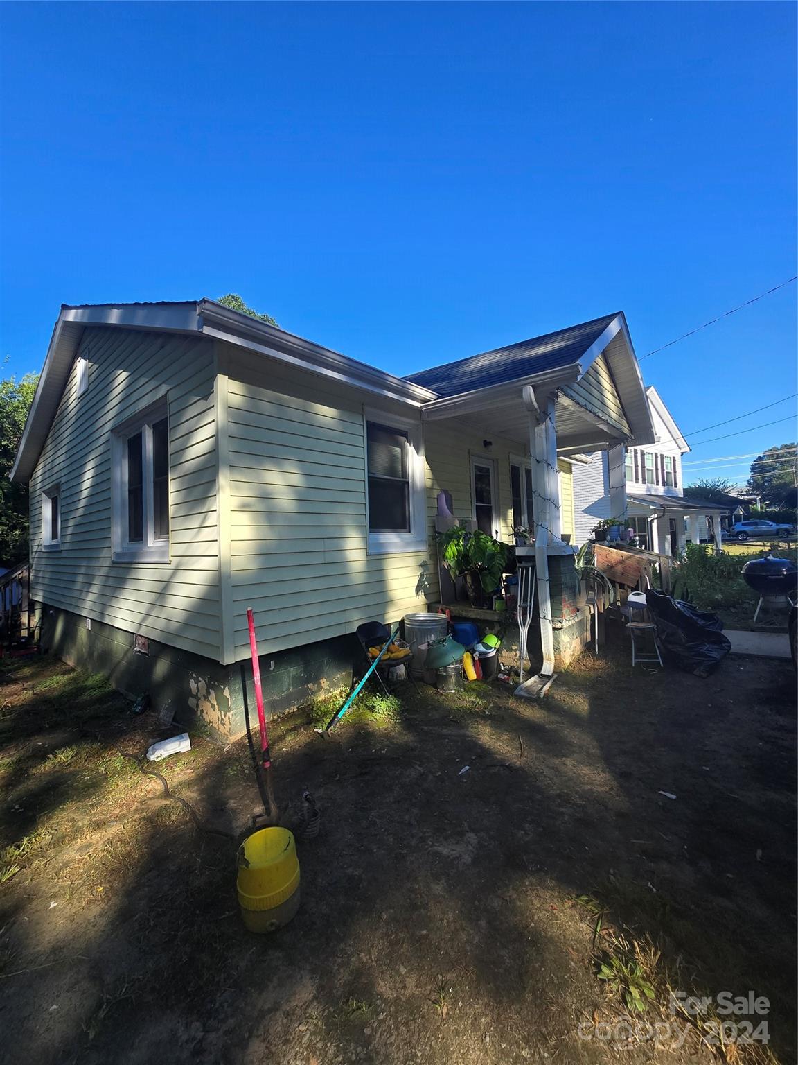 a view of a wooden house with a yard