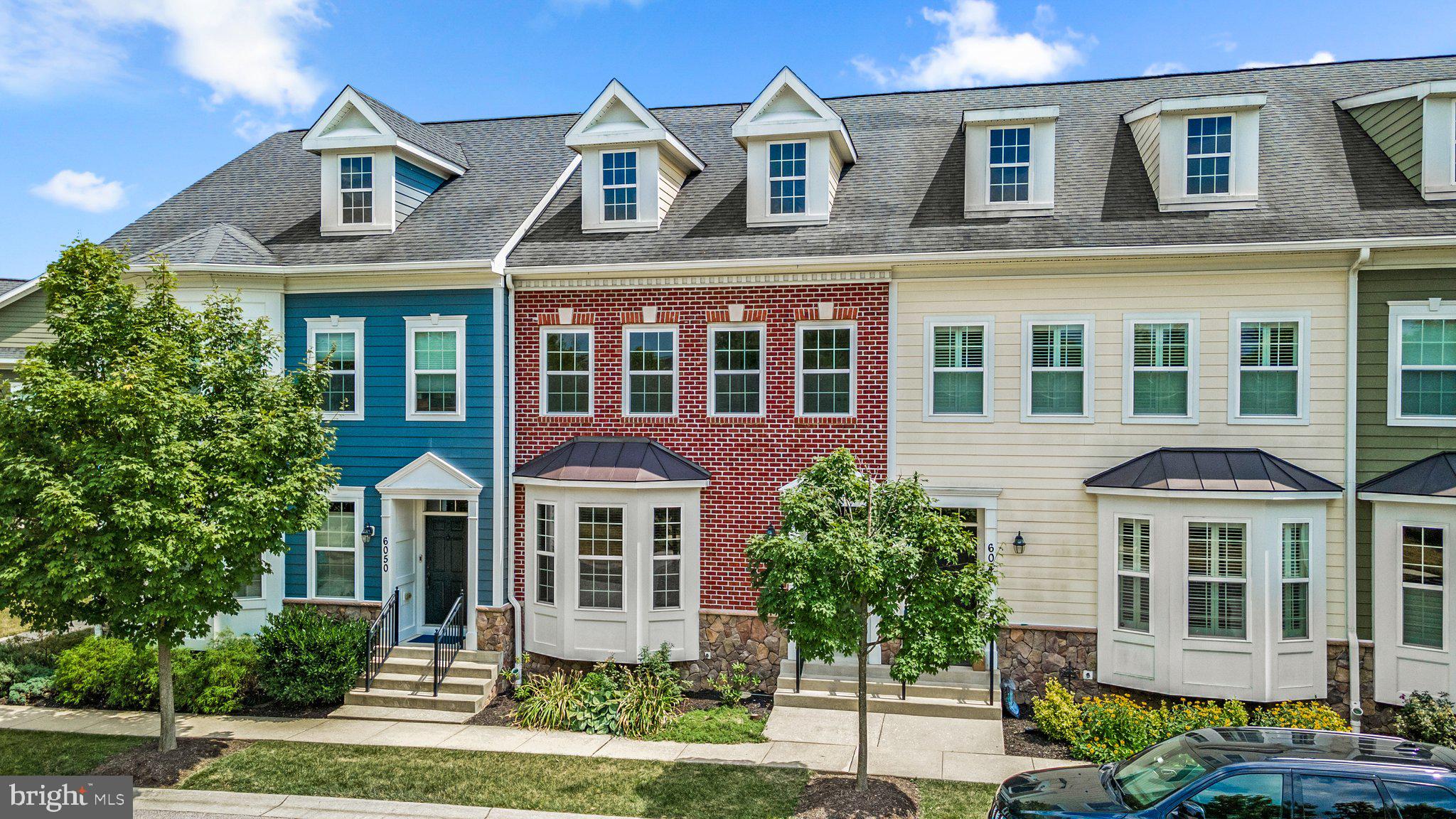 a front view of a residential apartment building with a yard