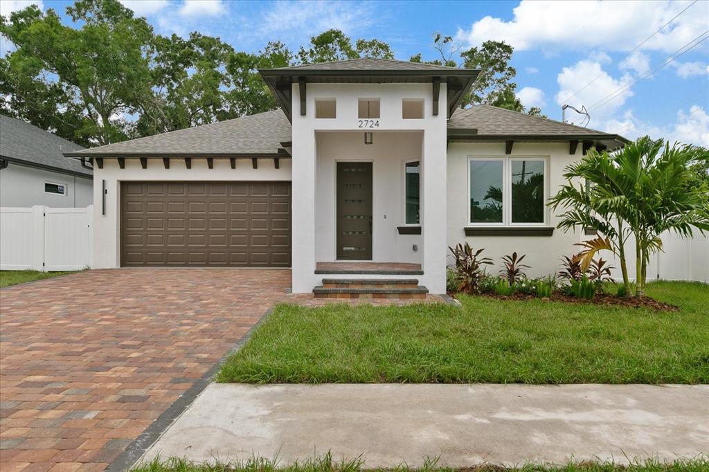 a front view of a house with a yard and garage