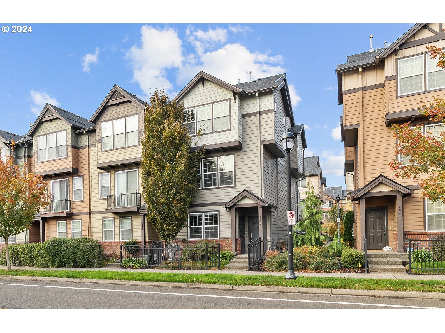 a front view of a residential apartment building with a yard