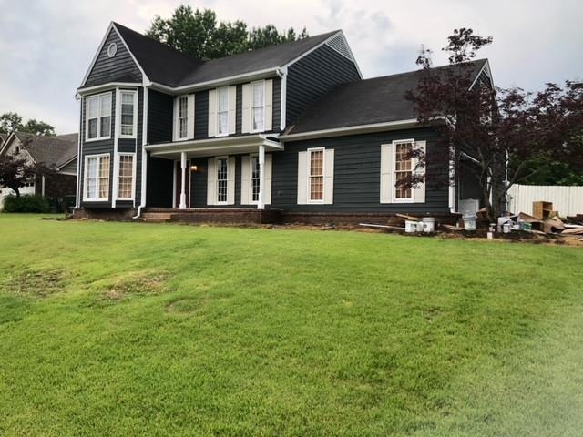 a front view of a house with a yard