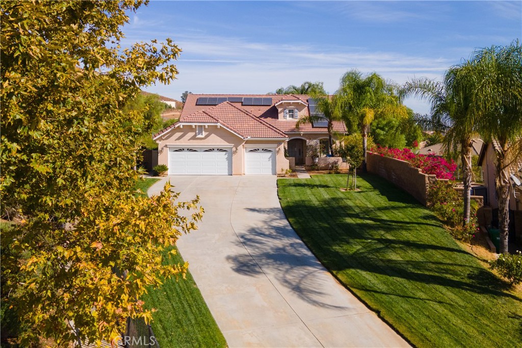 a view of a house with a yard and garden