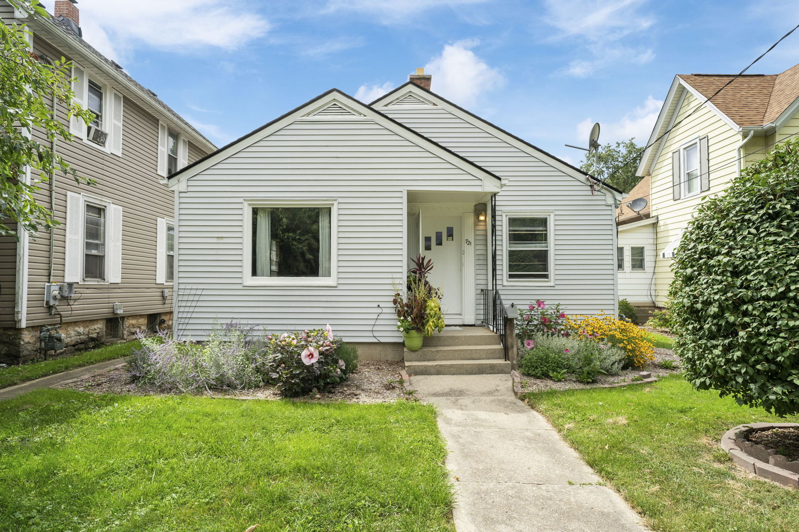 a view of a house with a yard and plants