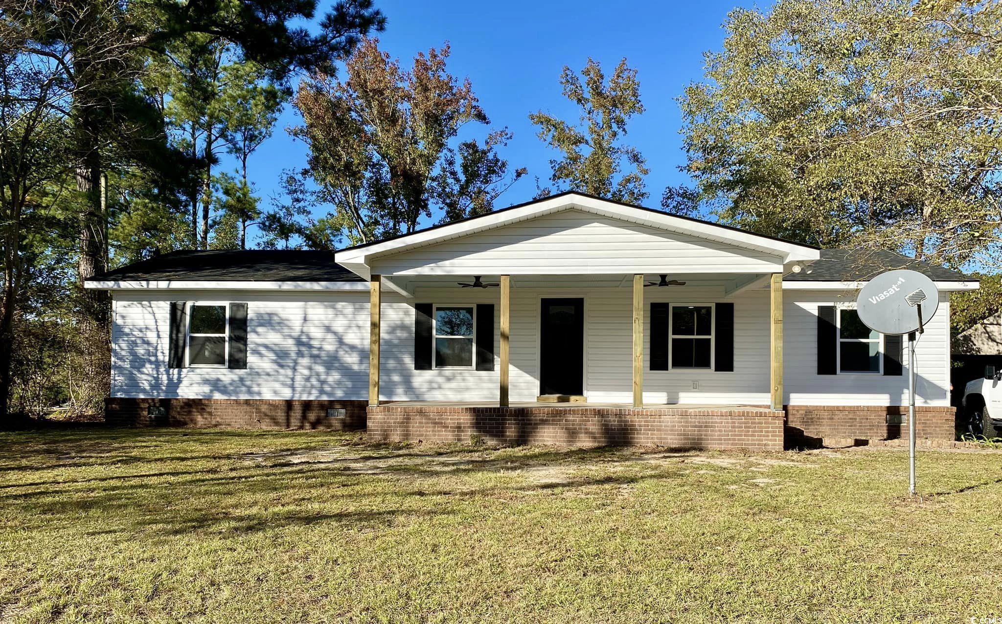 View of front of property with a front yard and ce