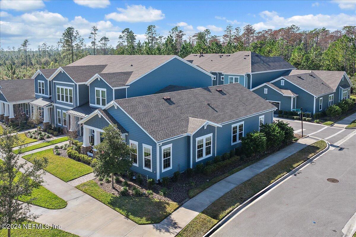 an aerial view of a house with a big yard