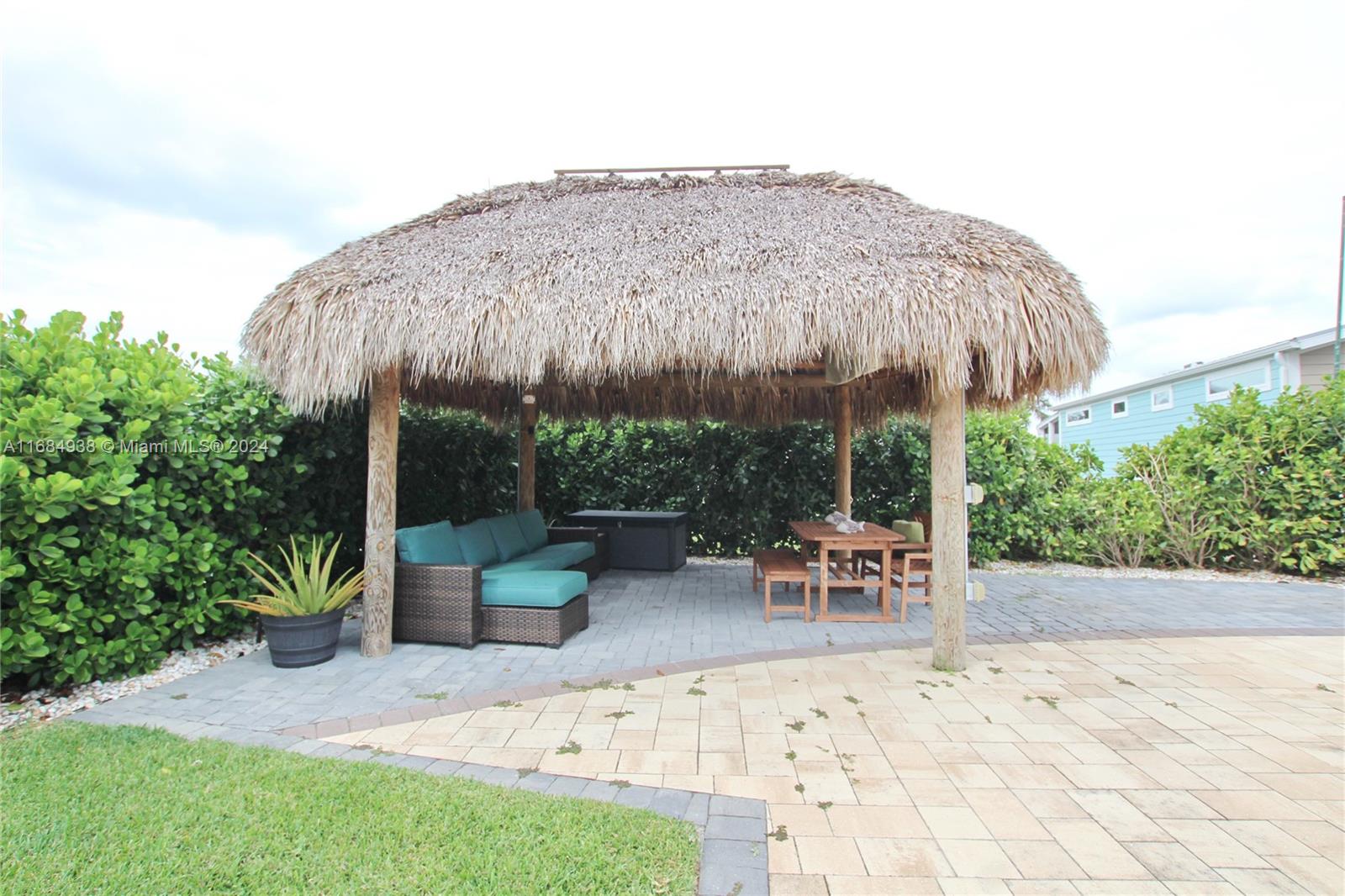 a backyard of a house with table and chairs