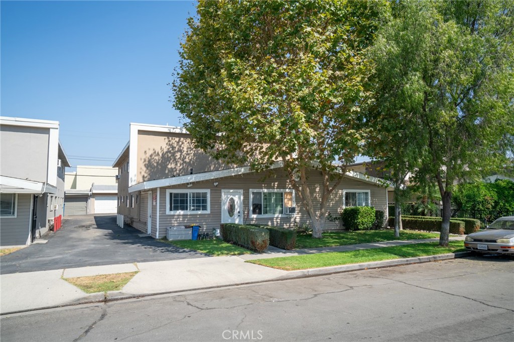 a view of house with outdoor space and parking