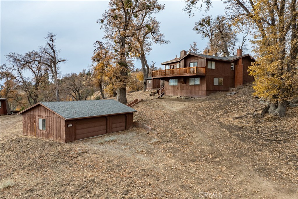 a wooden house with trees in front of it