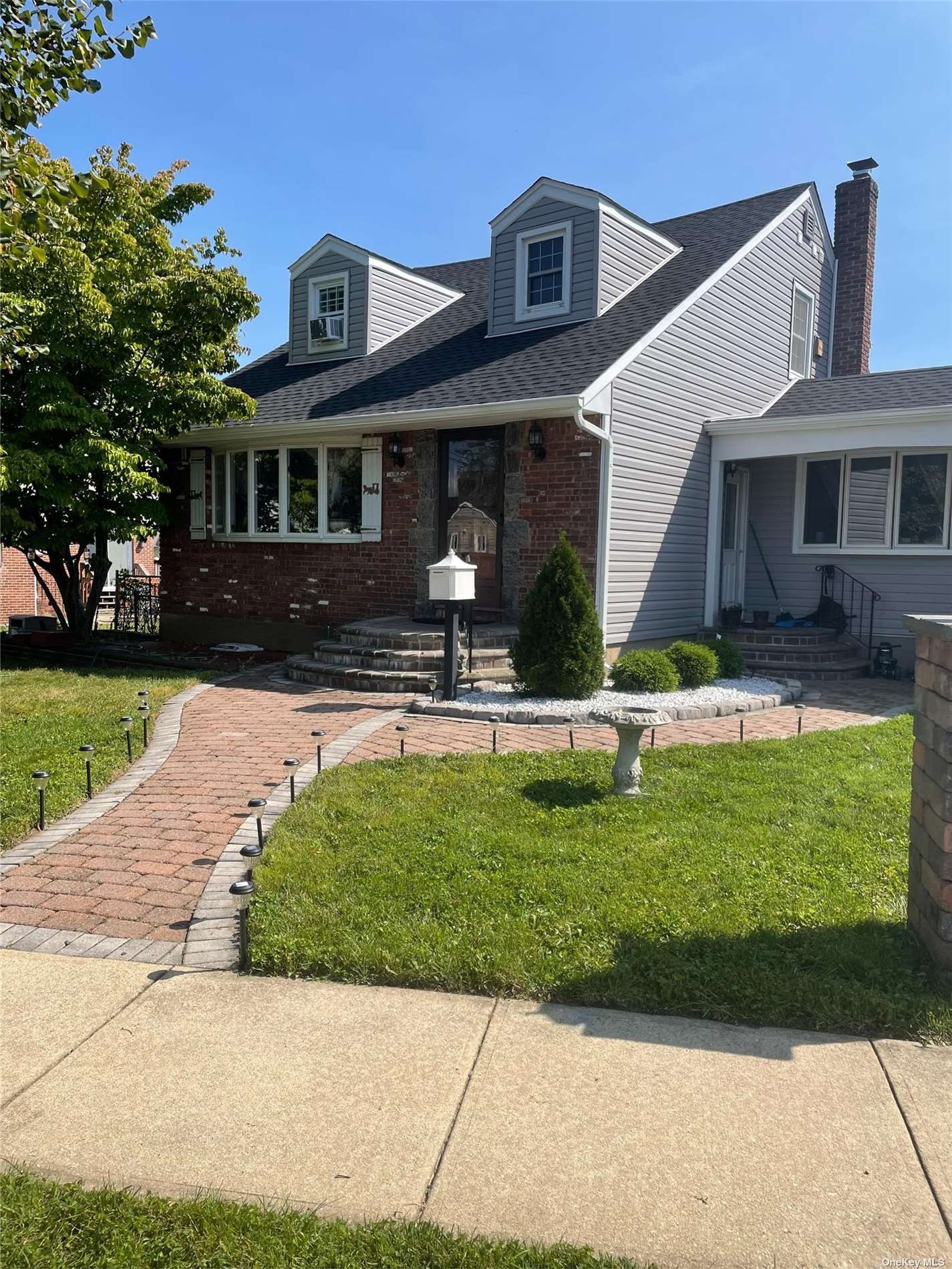 a front view of house with yard and outdoor seating