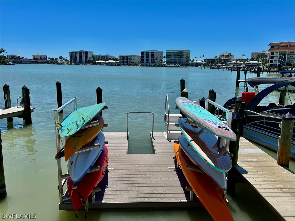 a view of a lake with couches chairs