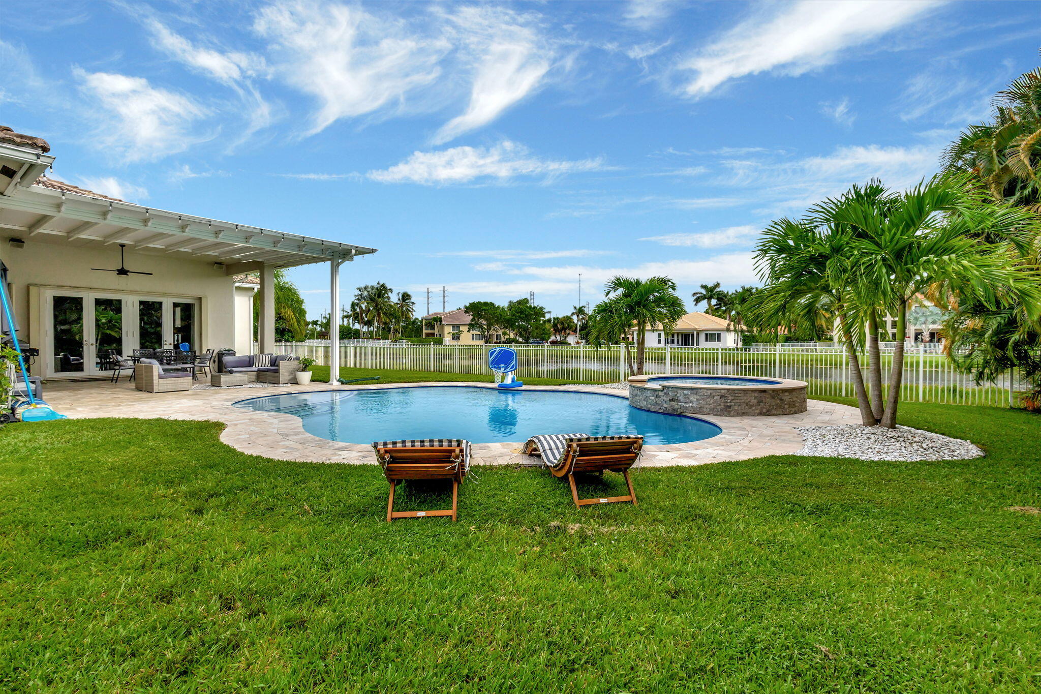 a swimming pool with outdoor seating and yard