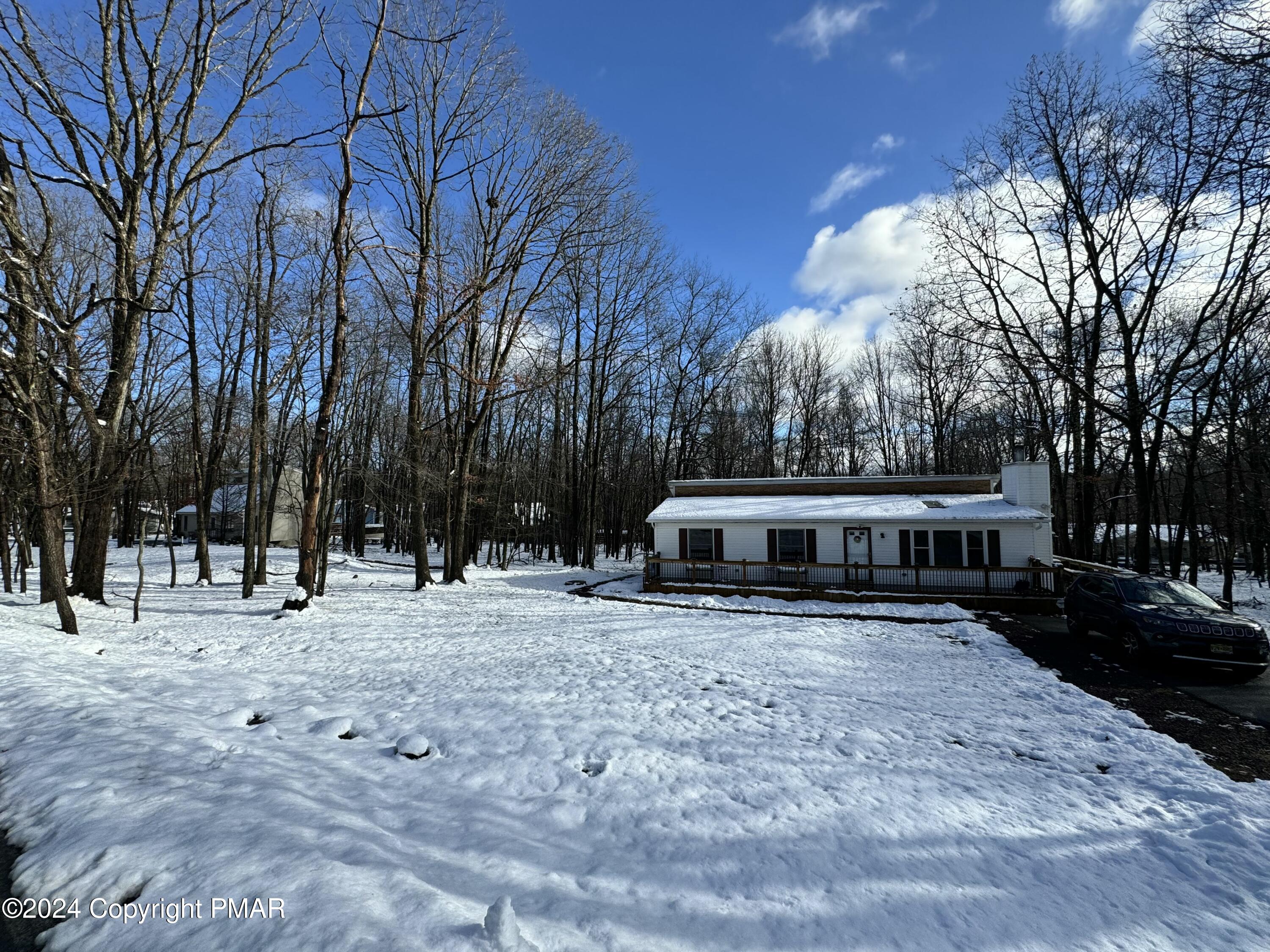 a view of a house with a yard covered in snow