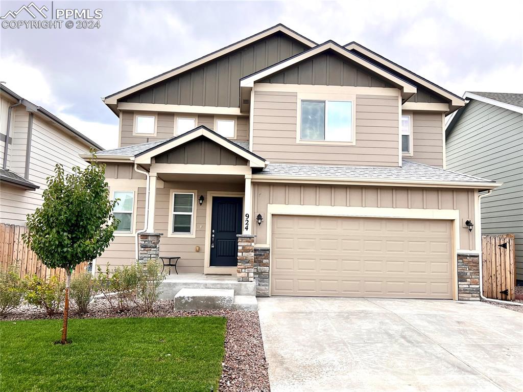 a front view of a house with a yard and garage