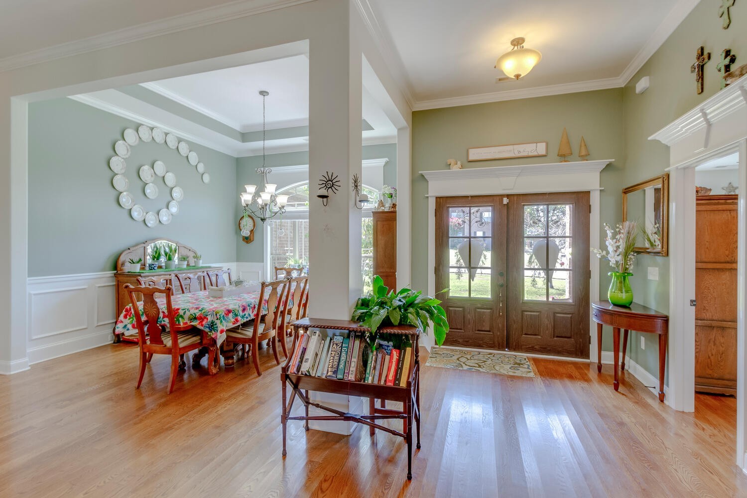 a view of a livingroom with furniture wooden floor and a large window