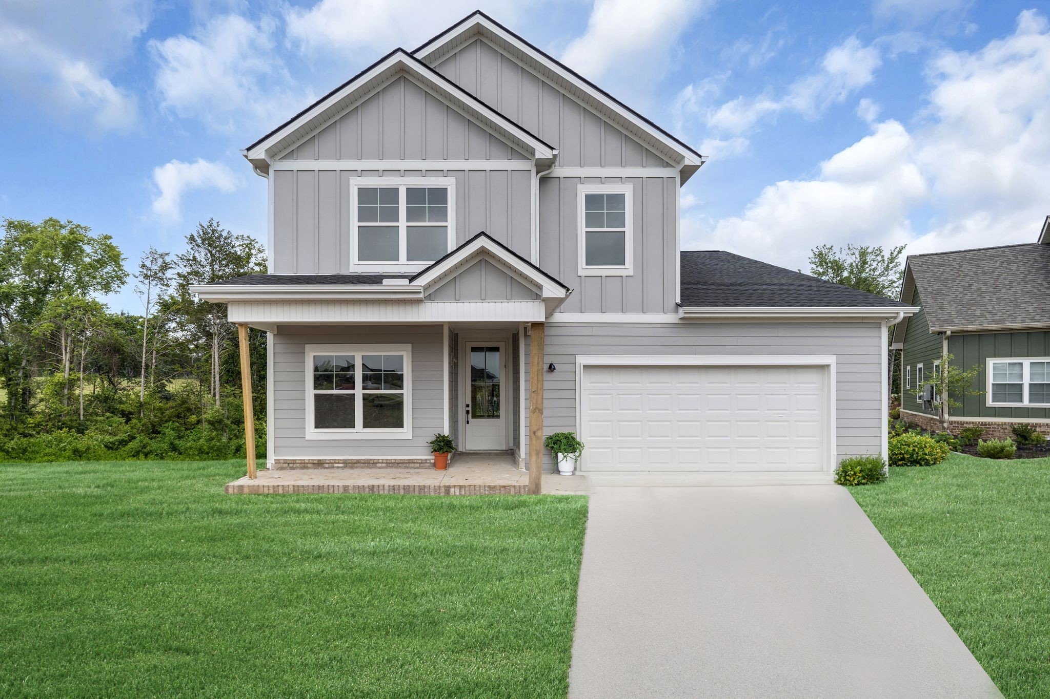 a front view of a house with a garden and yard