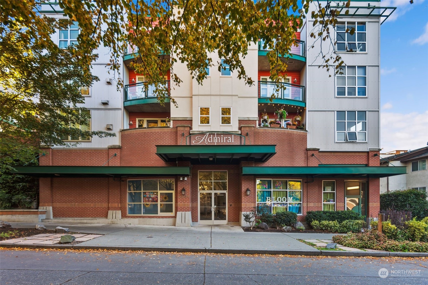 a front view of a building and car parked