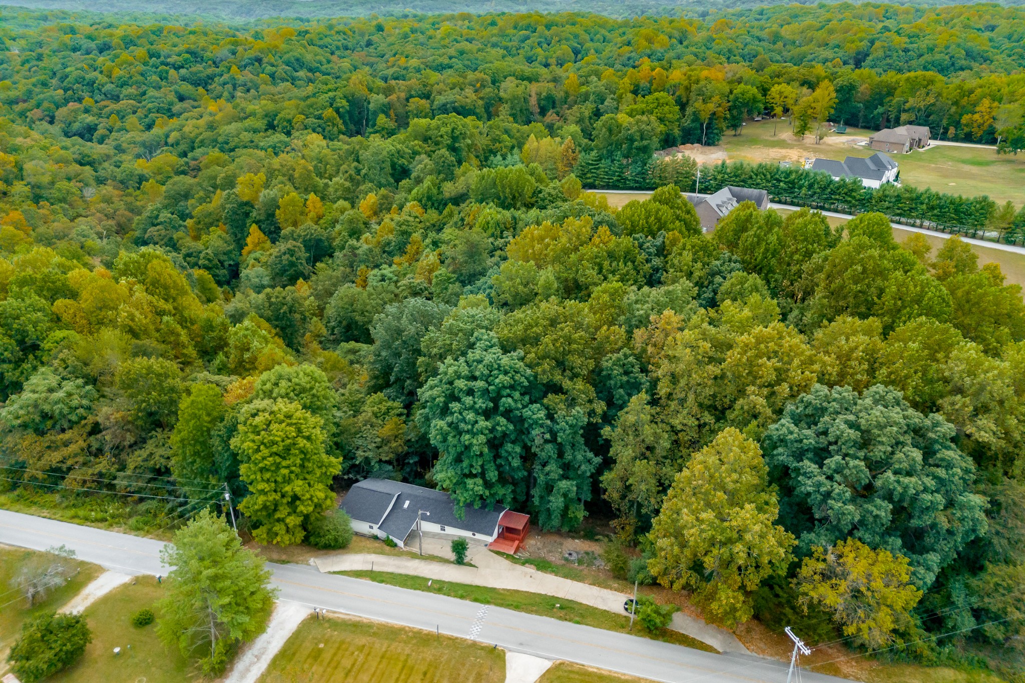 an aerial view of a house with swimming pool outdoor seating and yard