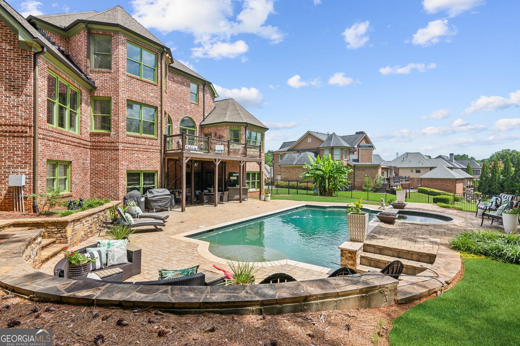 a view of a house with swimming pool and sitting area