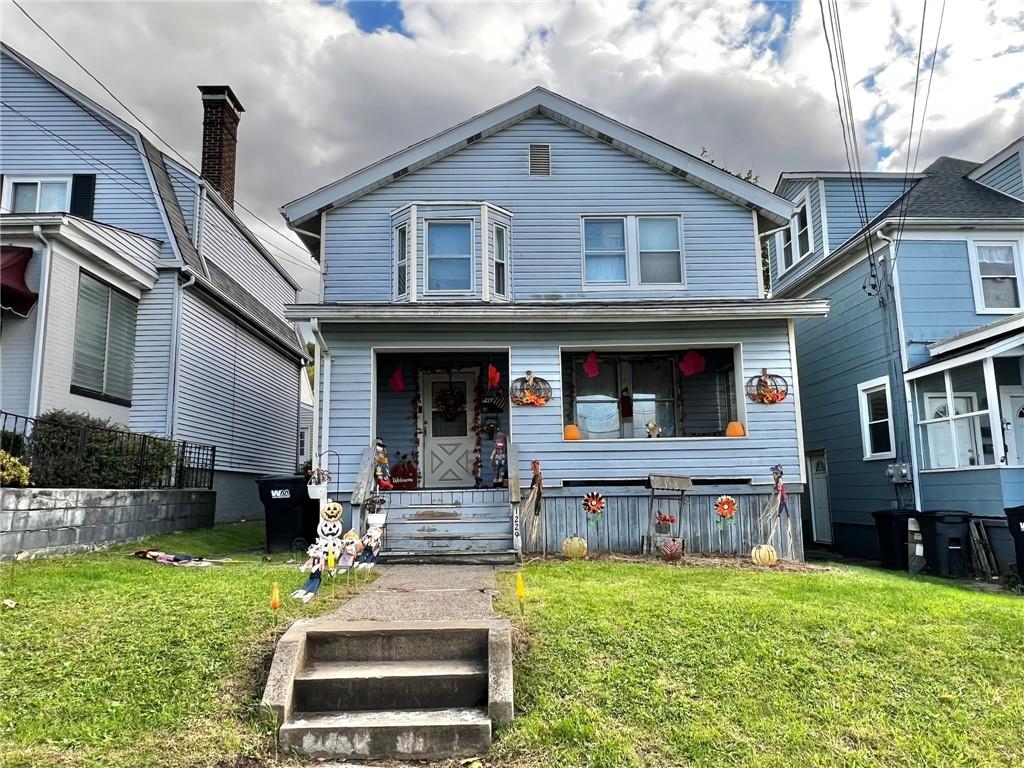 a front view of a house with a yard