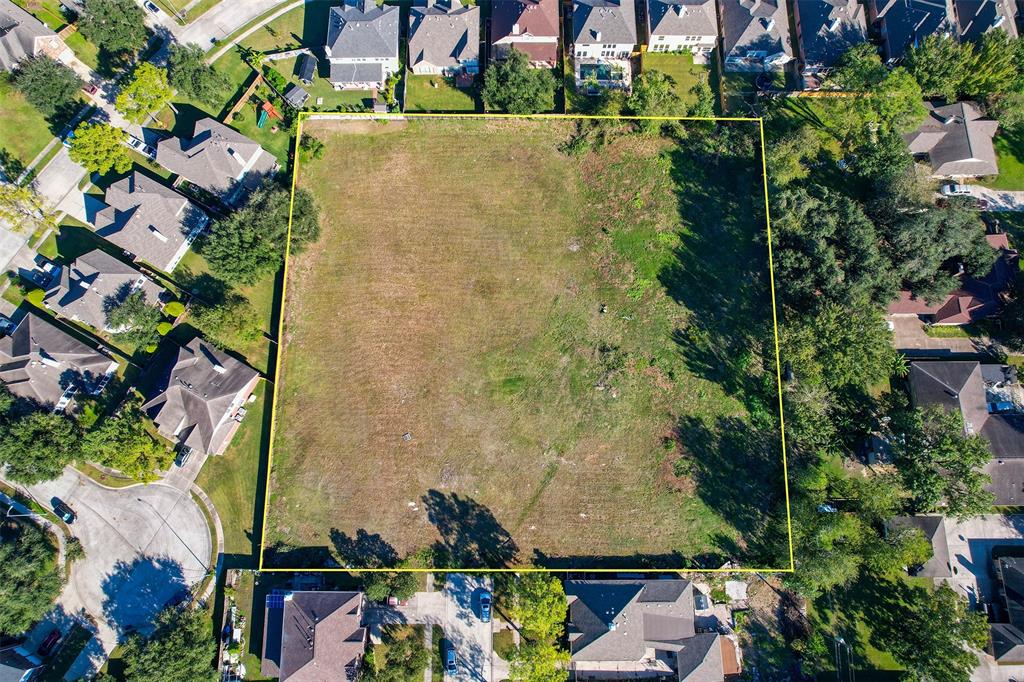 an aerial view of a houses with yard