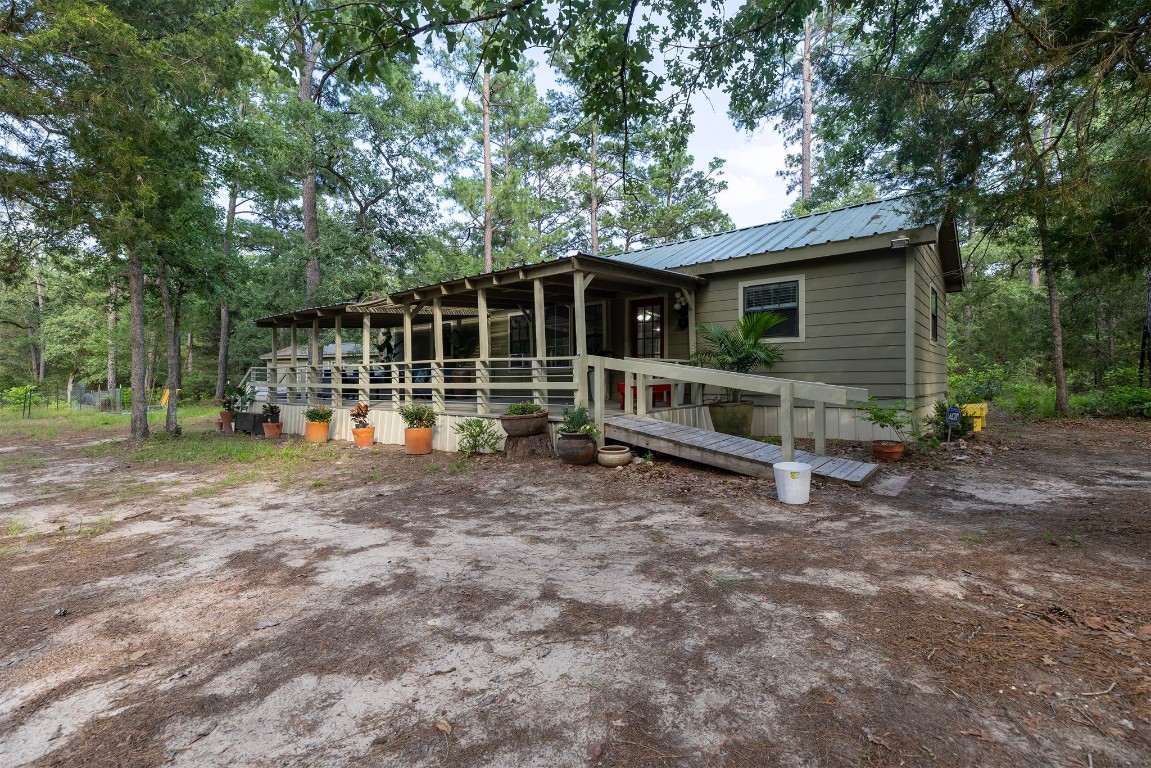 a view of backyard with wooden fence and a large tree