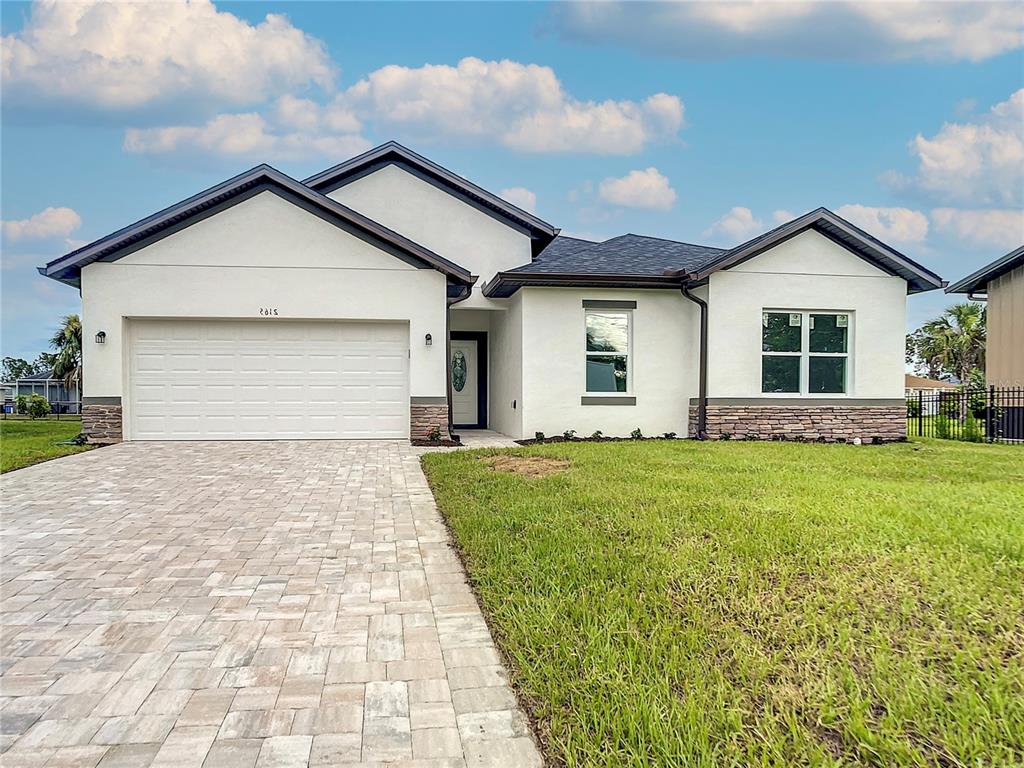 a front view of house with yard and green space