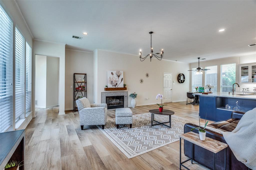 a living room with fireplace furniture and a wooden floor