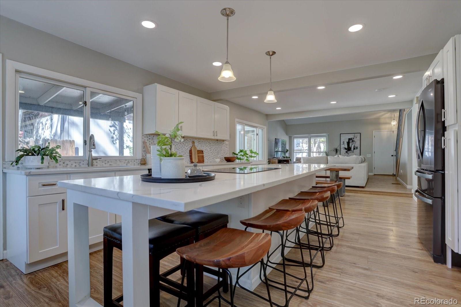 a large kitchen with a table and chairs