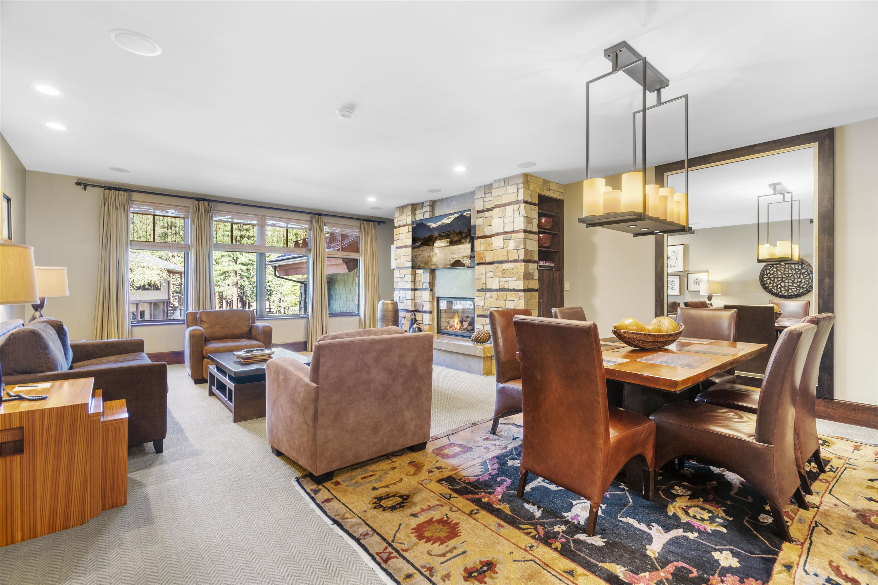 a dining room with furniture a chandelier and wooden floor