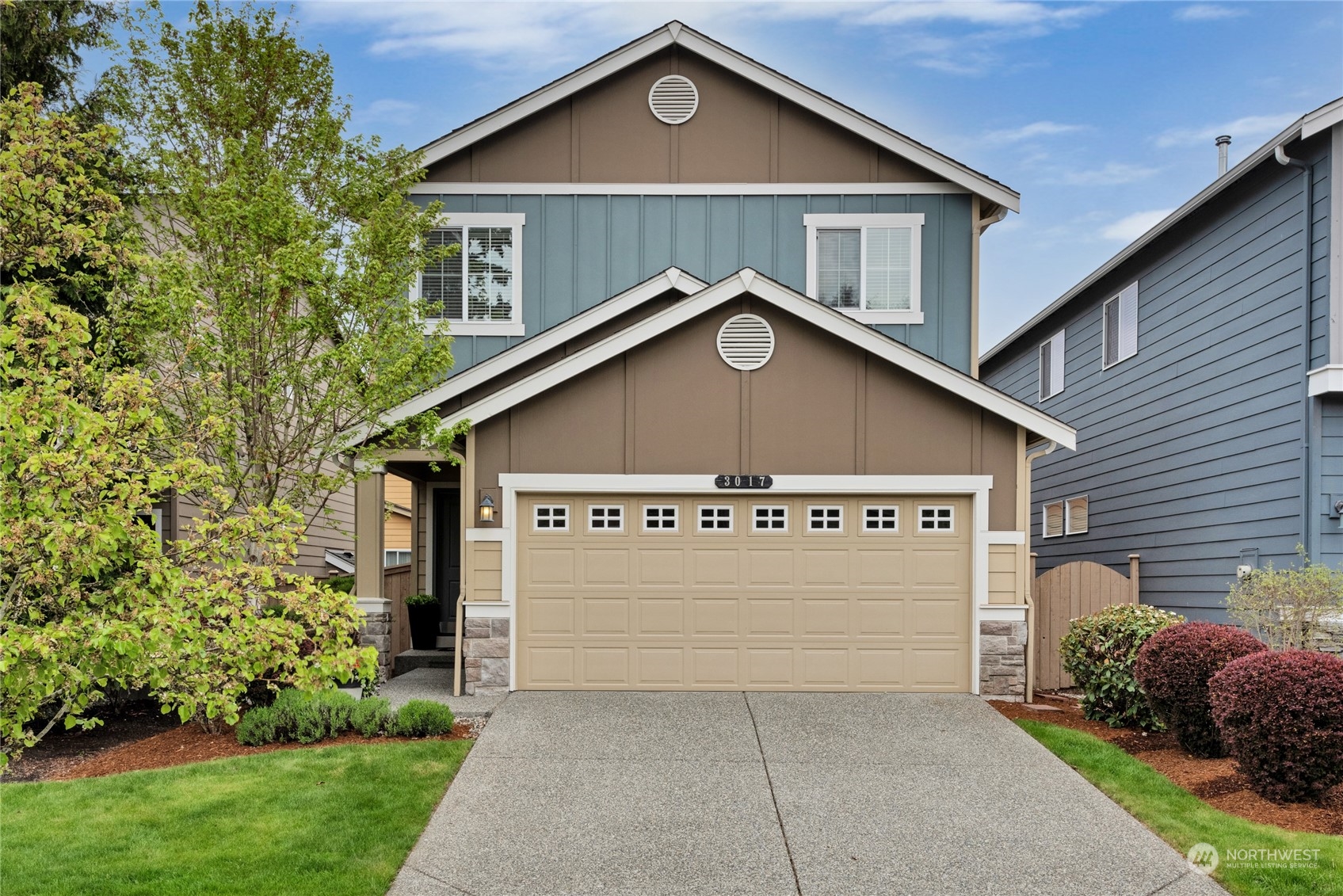 a view of a house with a yard and garage