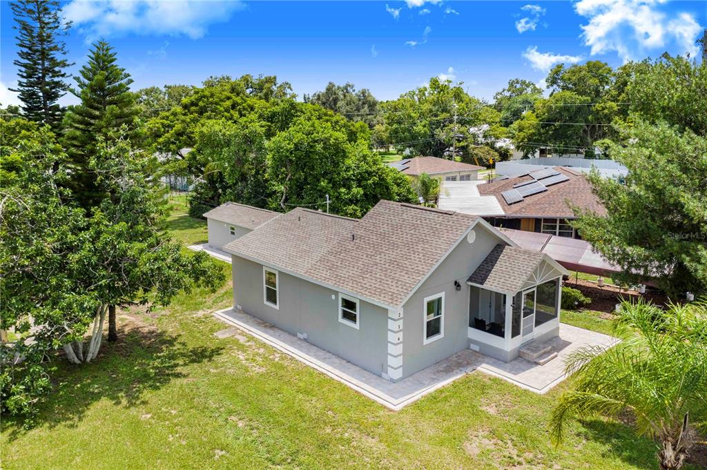 an aerial view of a house with swimming pool and big yard