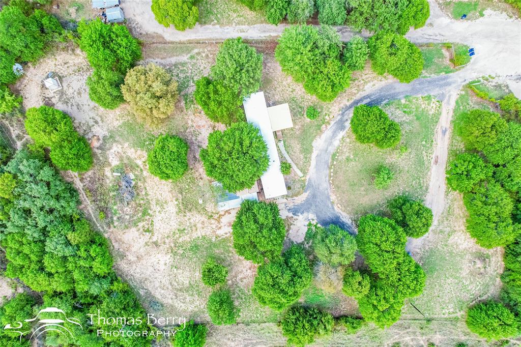 an aerial view of a house with a yard and plants