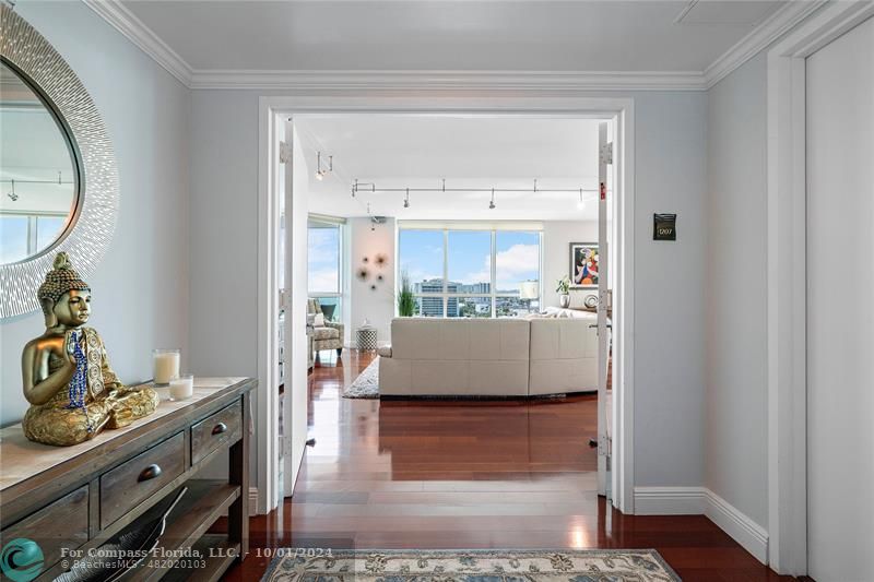 a room with kitchen island a stove and a wooden floor