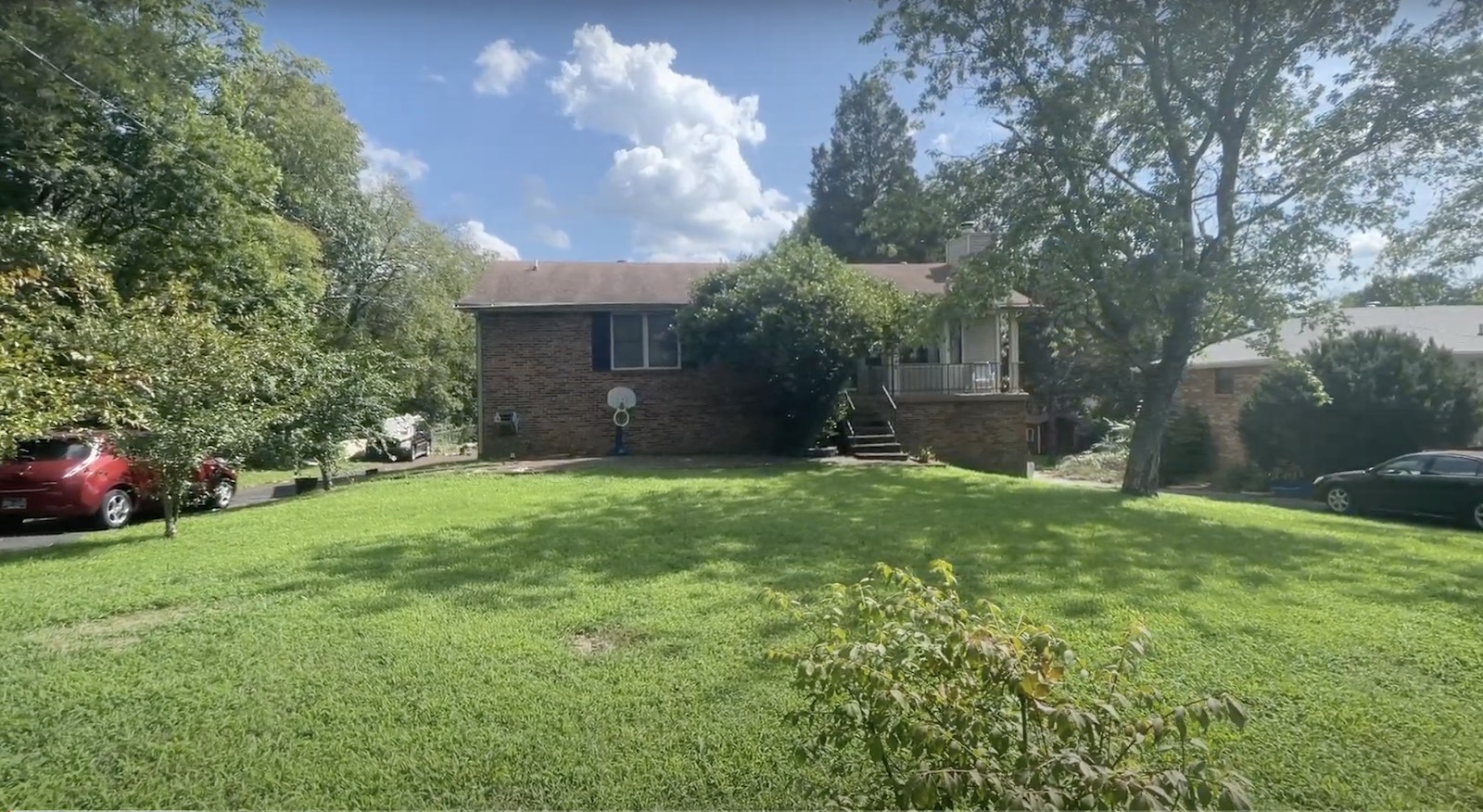 a view of a backyard with large trees