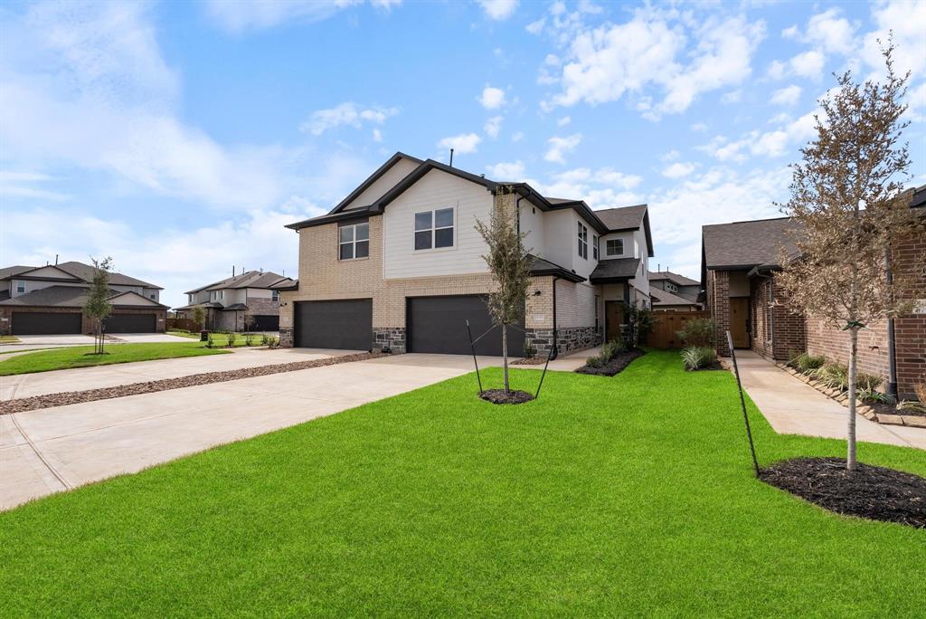 a view of a house with a yard and sitting area