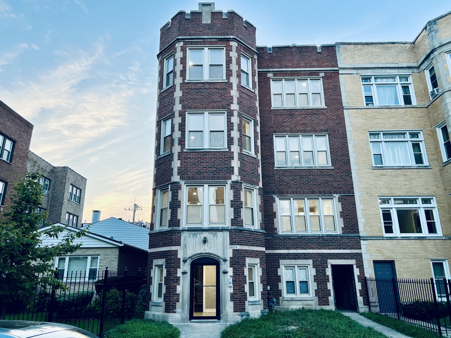 a front view of a residential apartment building with a yard