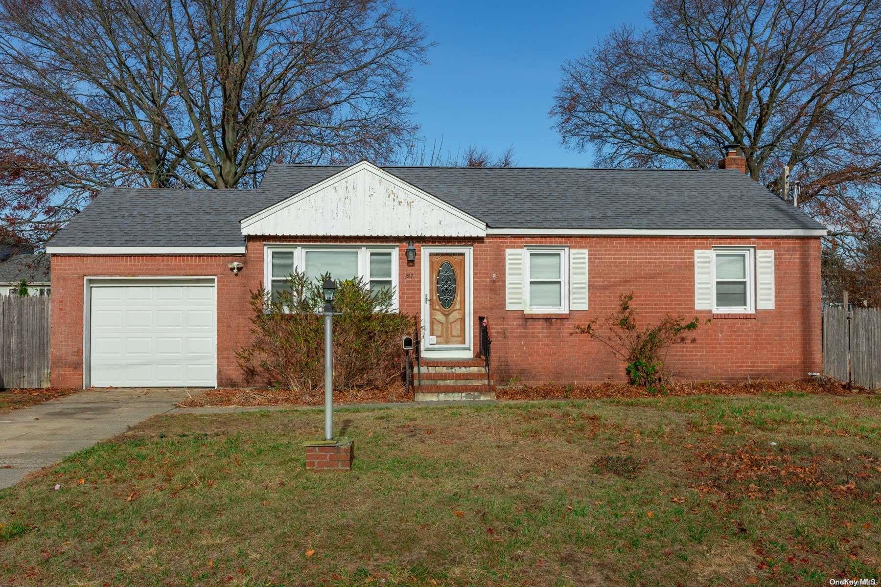 a front view of a house with a garden and yard