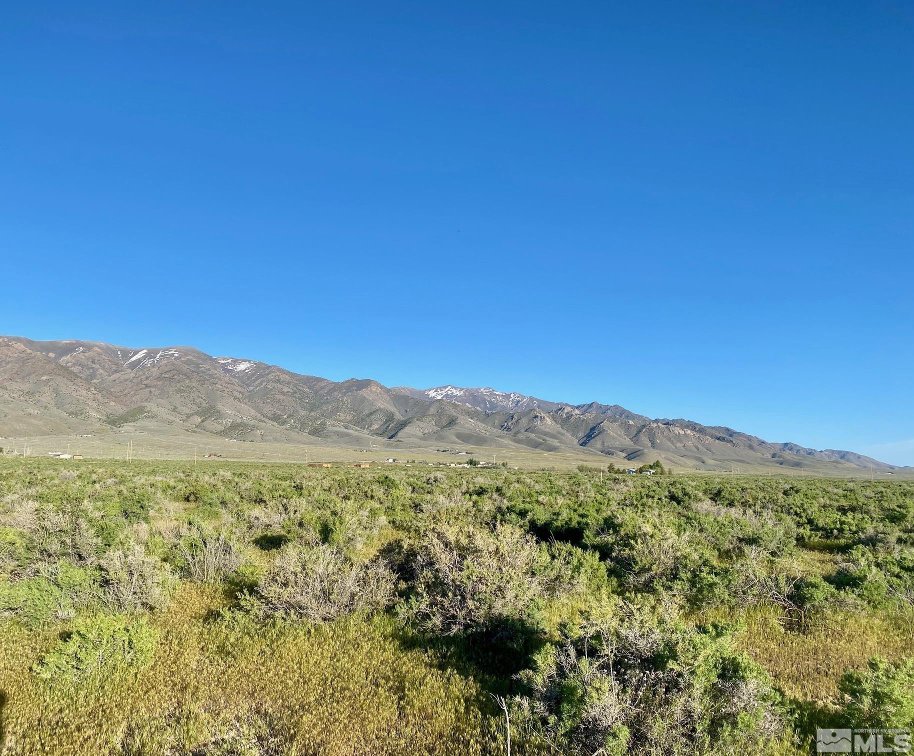 a view of a mountain range with lush green forest