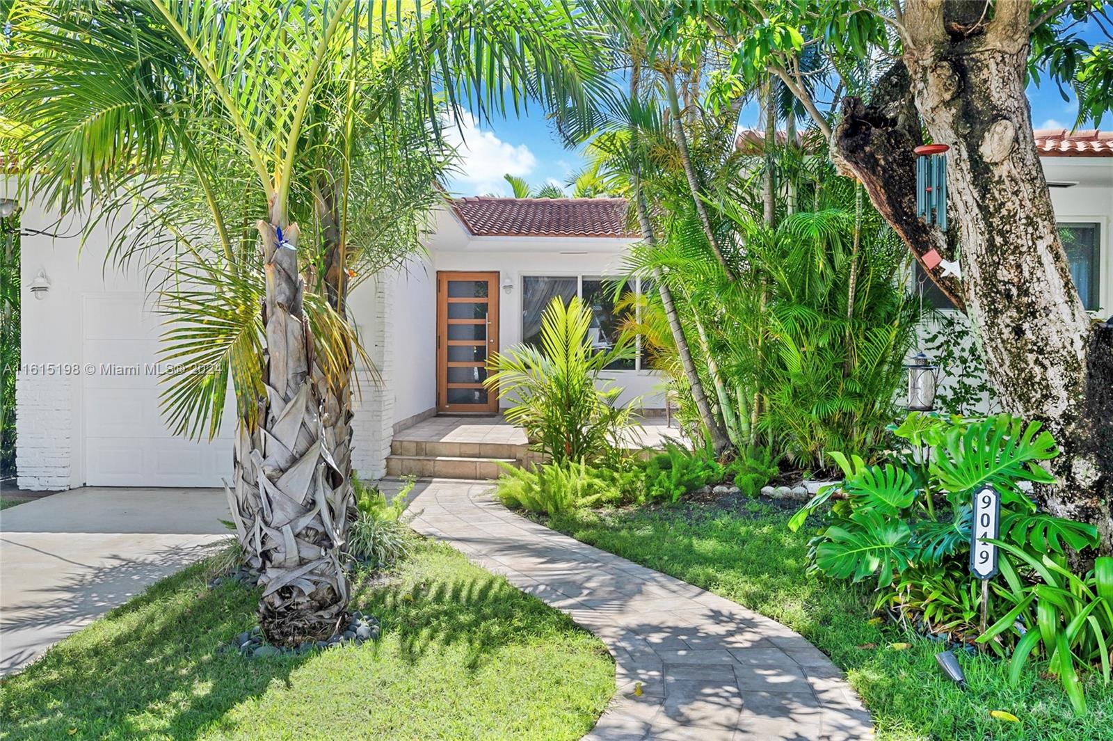 a front view of a house with garden