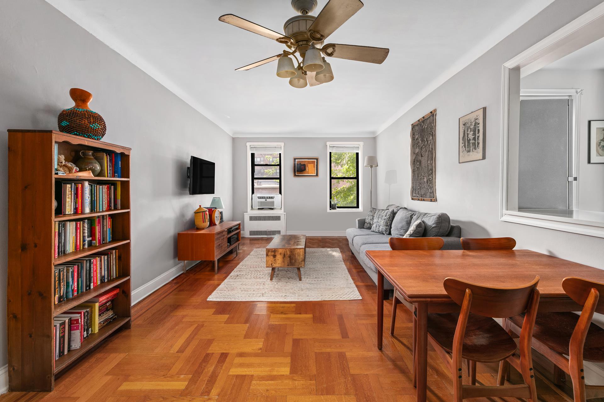 a living room with furniture and a book shelf