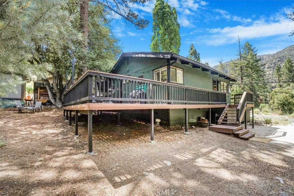 a view of a house with a yard and sitting area