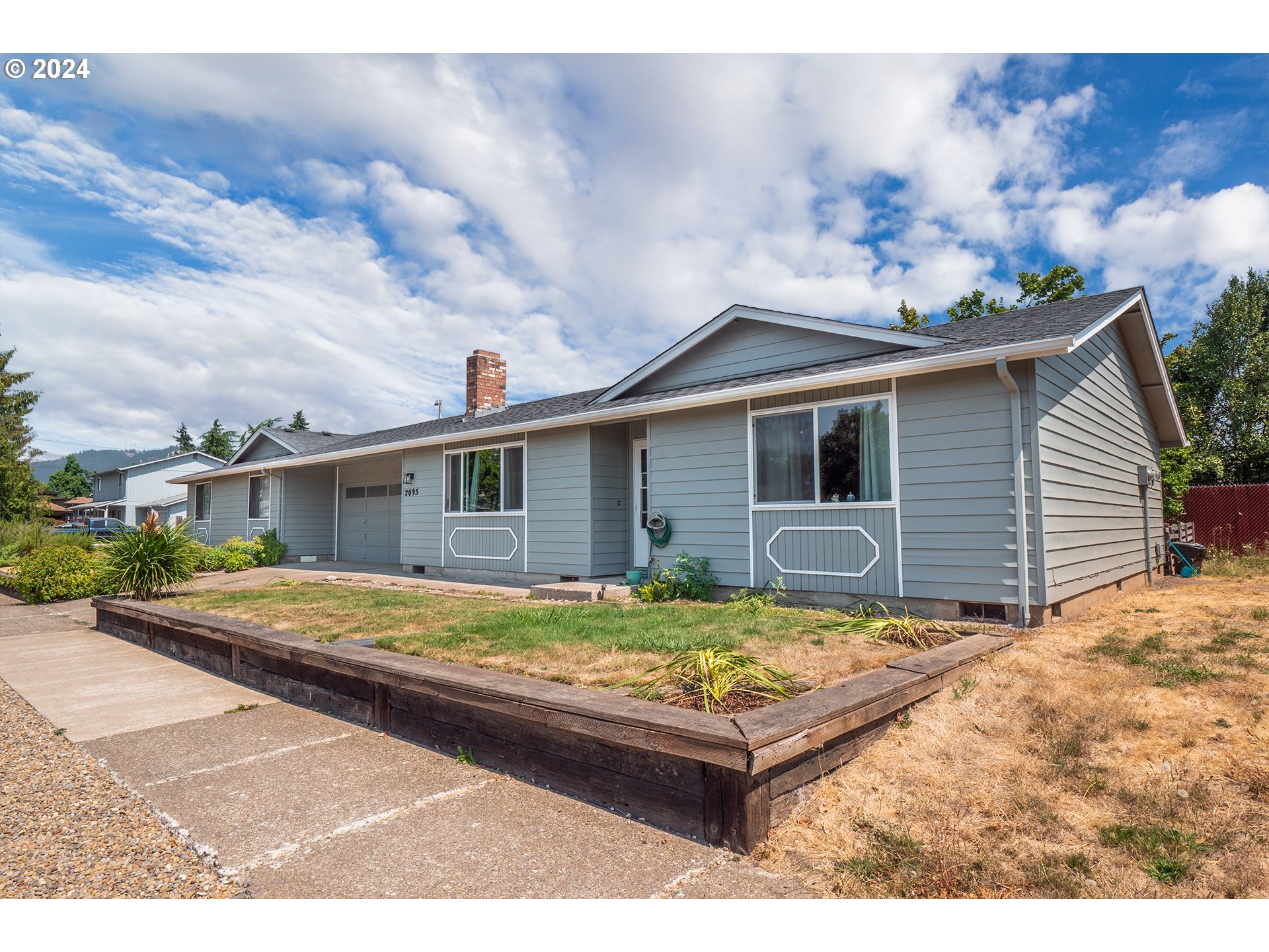 a view of house with yard outdoor seating area and barbeque oven