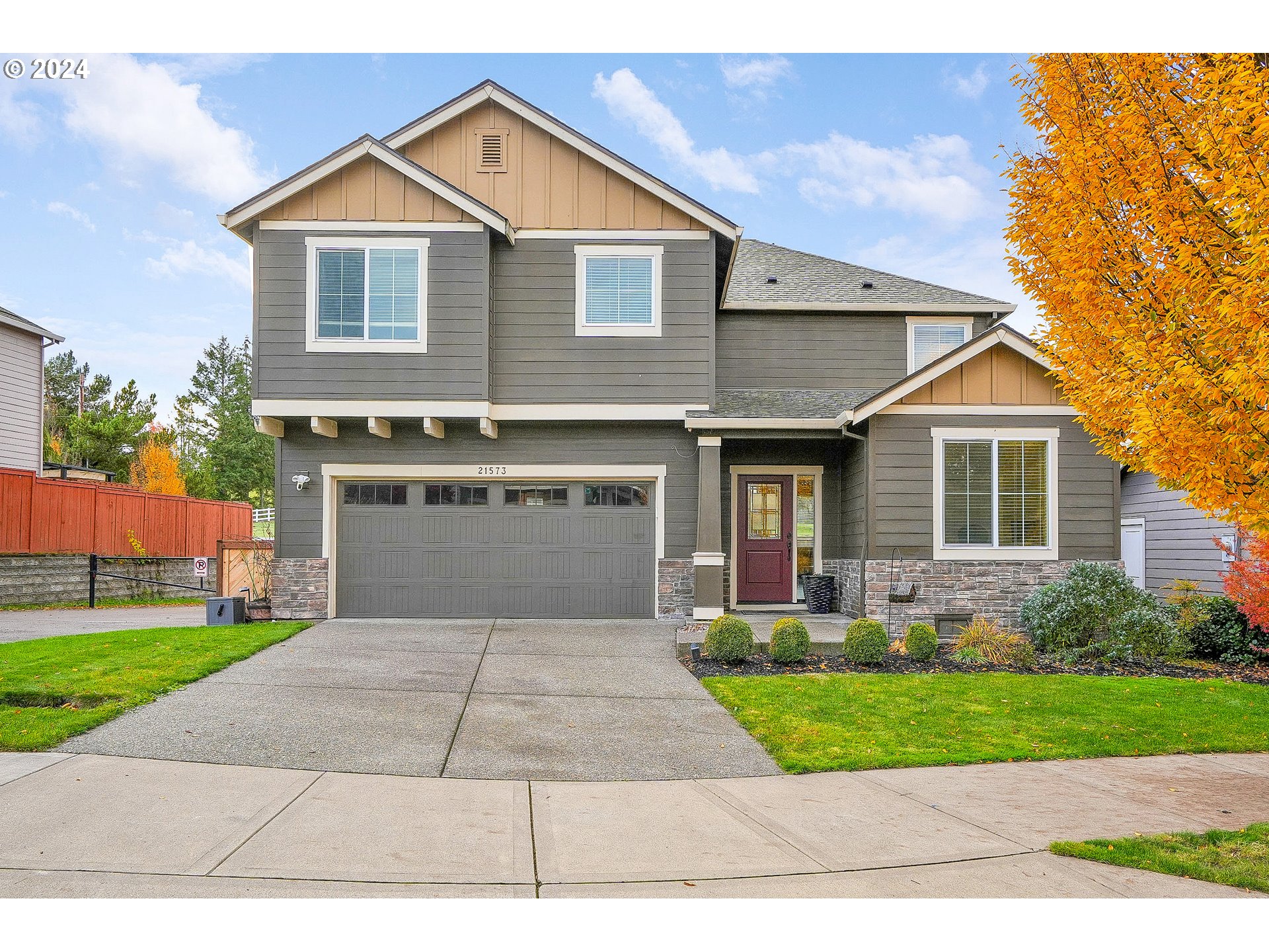 a front view of a house with a yard and garage