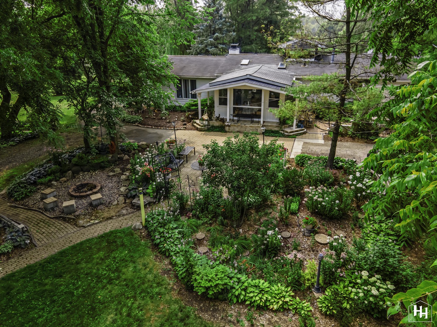 an aerial view of a house with garden space and street view