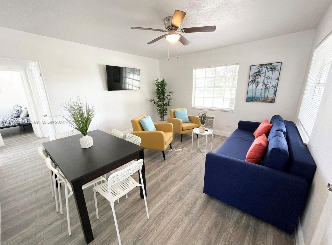 a living room with furniture and a wooden floor