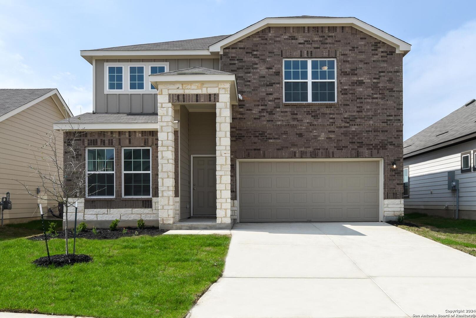 a front view of a house with a yard