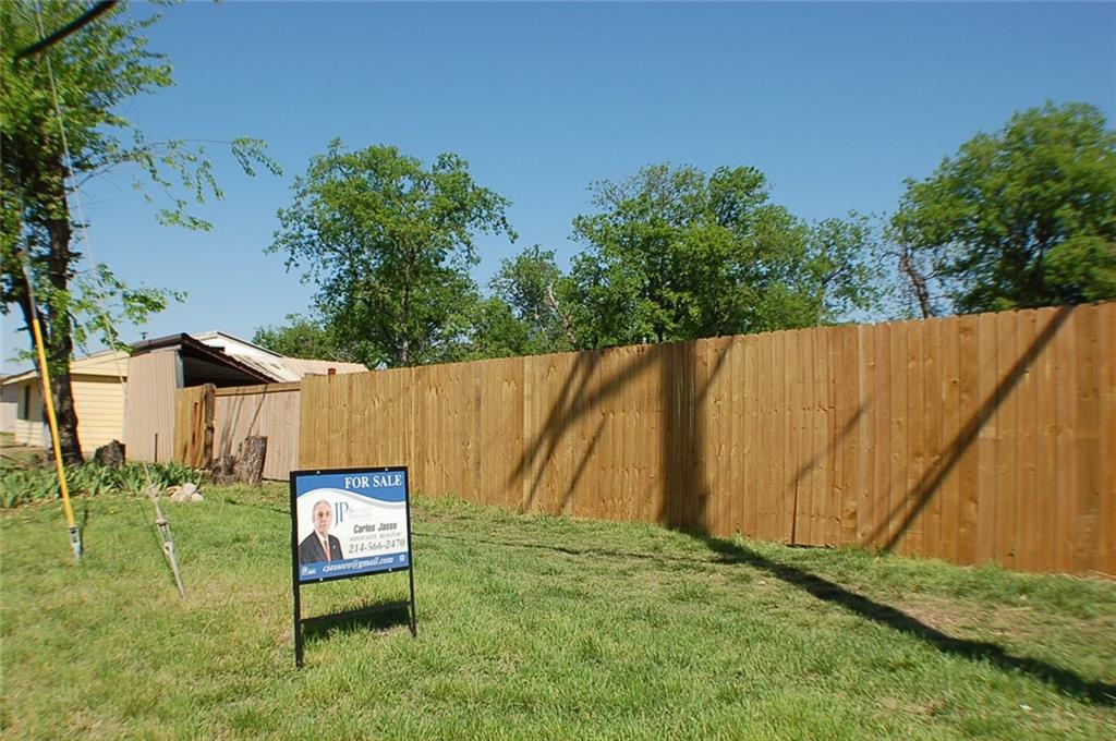 a view of a backyard with table and chairs