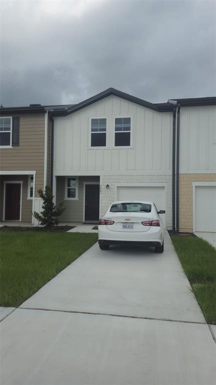 a back view of a house with a yard