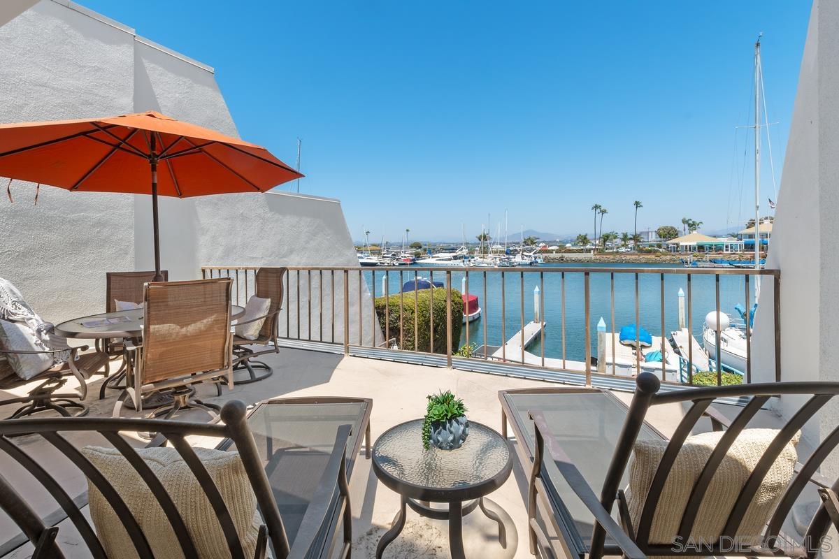 a view of a patio with furniture and umbrella