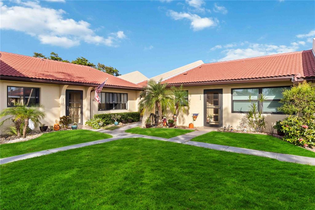 a front view of a house with a garden